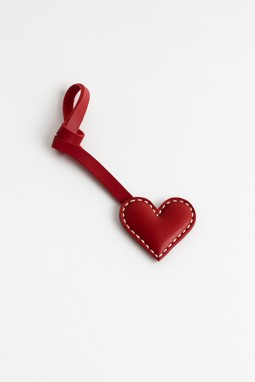 Red heart-shaped keychain on a white background