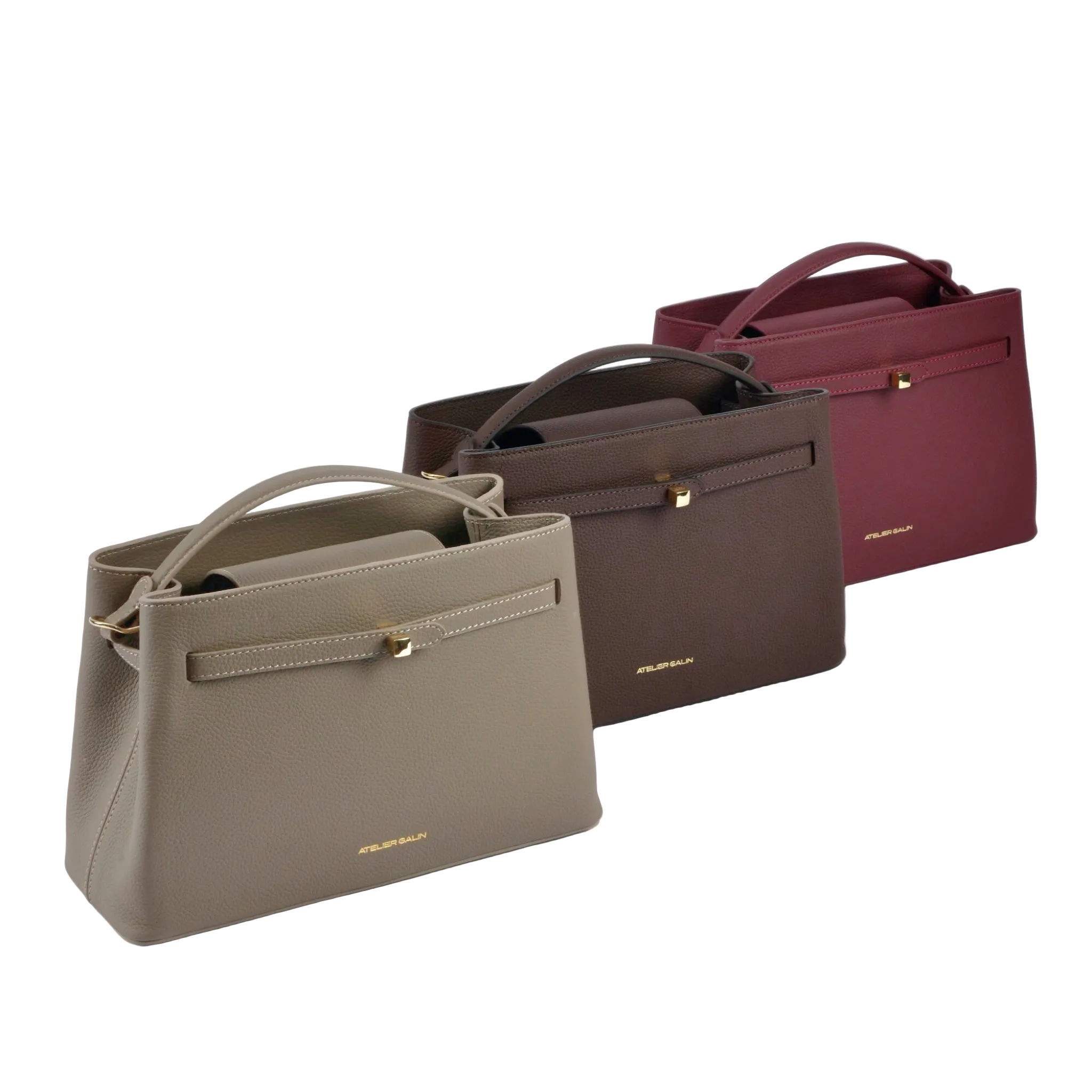 Three handbags in beige, brown, and red on a white background