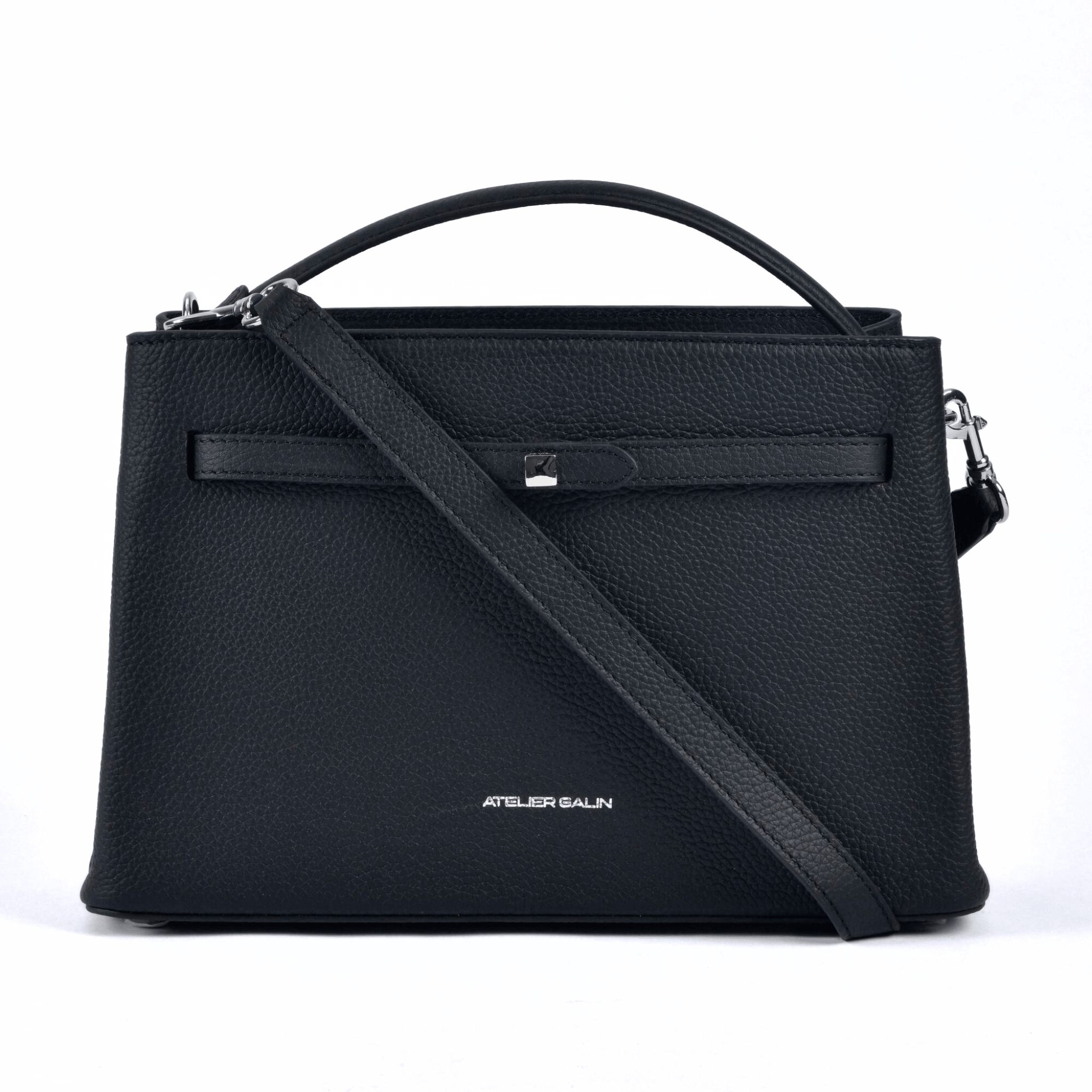 Black atelier galin cube lock handbag with silver hardware and brand logo detachable strap hanging across the front of the bag