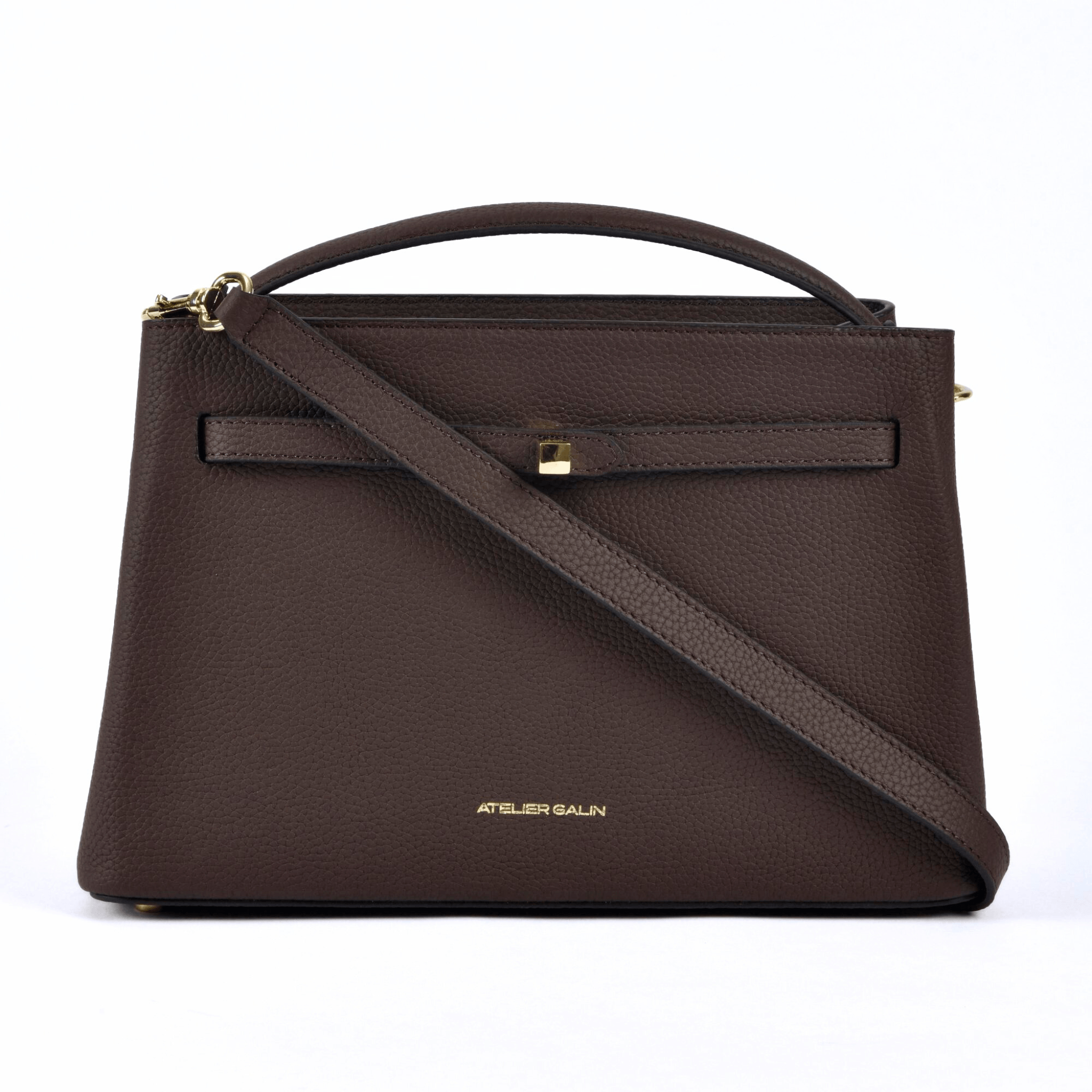 atelier galin cube lock handbag in chocolate brown lwg gold certified grained leather and gold hardware shoulder strap across the bag view