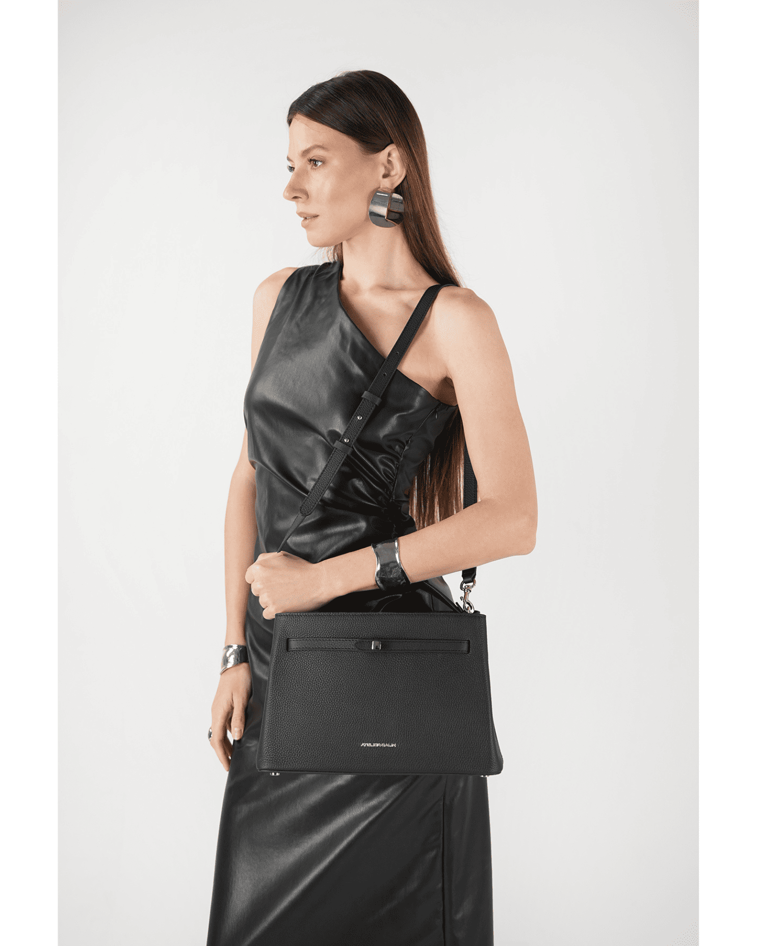 Model wearing Atelier Galin Cube Lock bag in black with silver hardware outfit idea