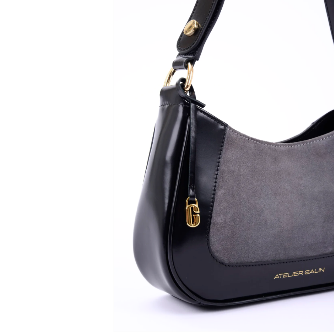 Black and gray suede handbag with gold hardware atelier galin white background