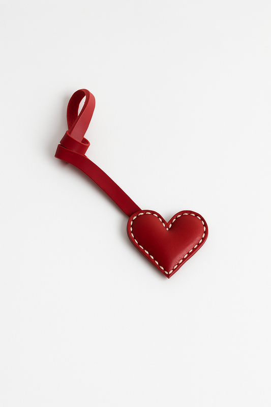Red heart-shaped keychain on a white background