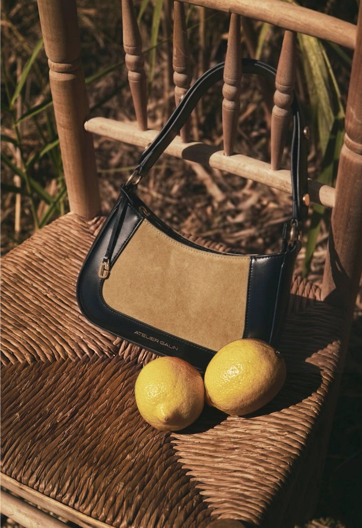 jasmine hobo bag in color tabac shot outside at a field with lemons in the summer.