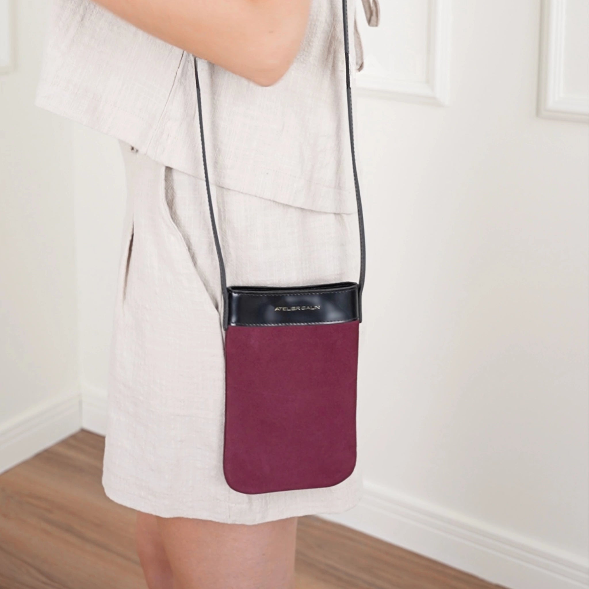 mila suede burgundy phone bag in deep red worn over the shoulder