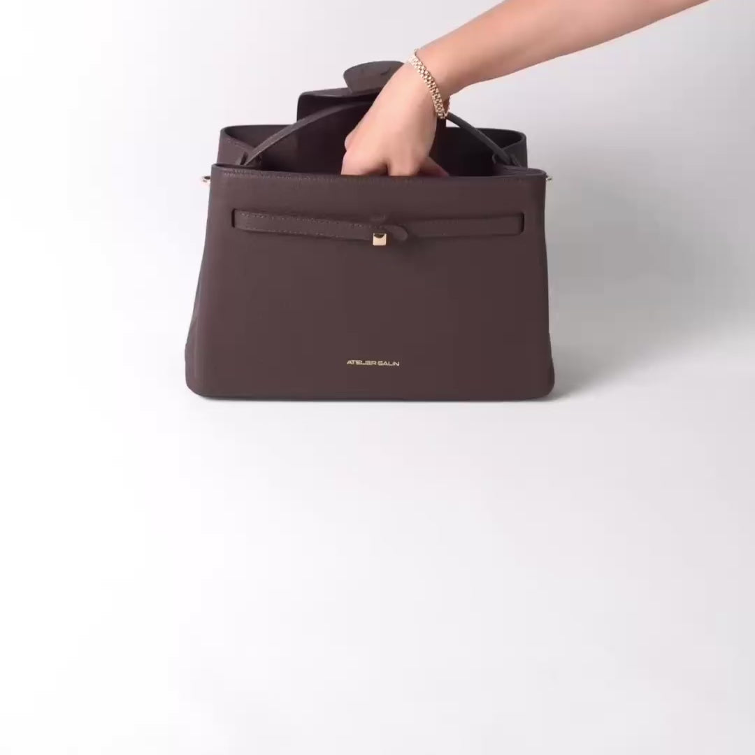 what fits inside cube lock bag is shown in the video. book, water bottle, wallet, phone and other daily essentials.