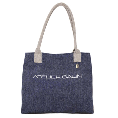 Blue tote bag with 'Atelier Galin' branding on a white background